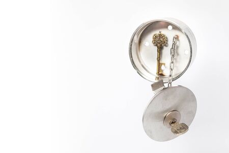 in a stainless steel key safe house hangs an antique key