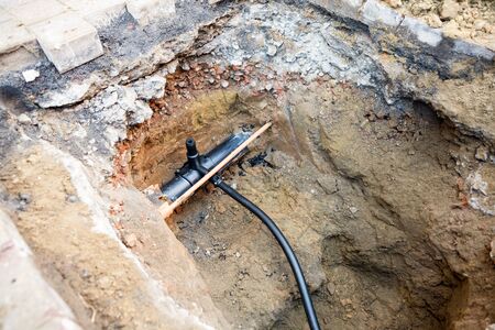in the ground there is a branch for natural gas for a houseの写真素材