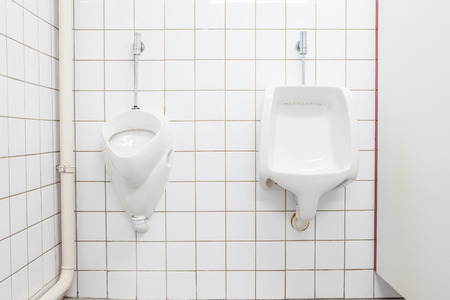urinals in an old building for men onlyの写真素材