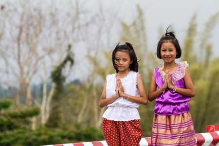 Two Thai cousins with traditional Thai costumeの写真素材