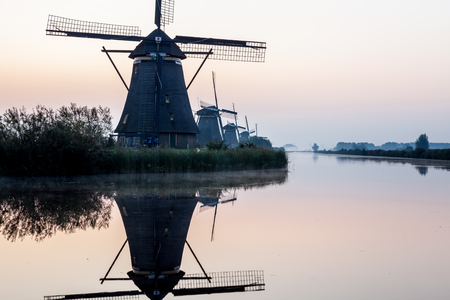 fog near the windmills in Kinderdijk in Hollandの写真素材