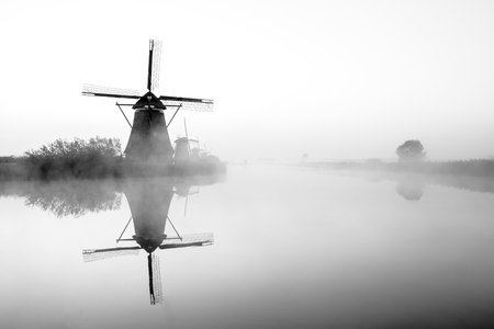 fog near the windmills in Kinderdijk in Hollandの写真素材