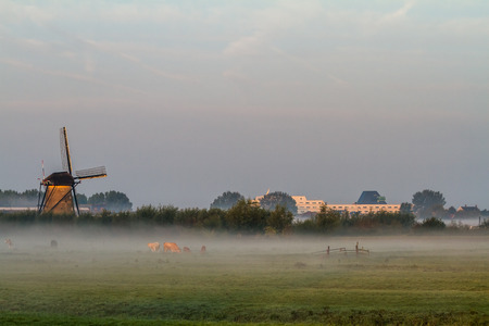 fog near the windmills in Kinderdijk in Hollandの写真素材