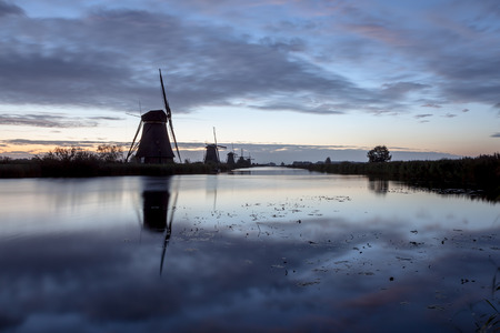 fog near the windmills in Kinderdijk in Hollandの写真素材