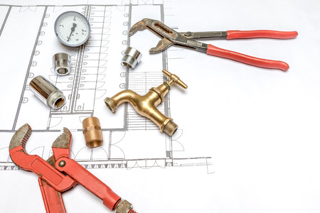 Plumbing Tools Arranged On House Plans whit wrench and water valvesの写真素材