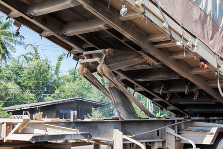 An truck trailer with tipper in close up of metal arm with hydrailic pumpの写真素材