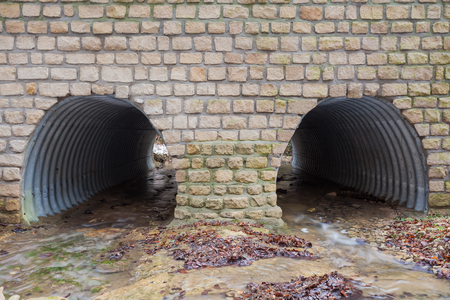 in the Ardennes there are water pipes under the roadの写真素材