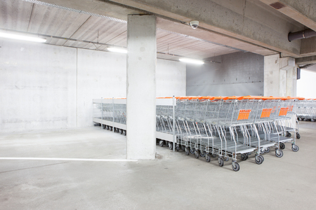 Underground park of a mall with columns and ventilation ductsの写真素材