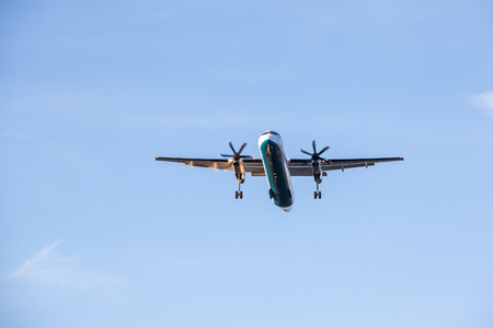 an large plane flies above the cityの写真素材