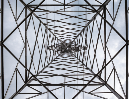 an construction of a high electricity pole with clouds in the airの写真素材