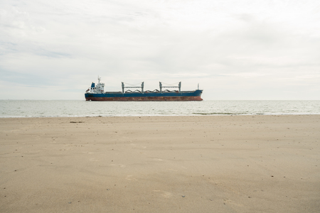 A cargo ship is sailing at sea on the Dutch coastの写真素材