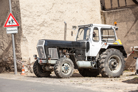tallest the street next to a traffic sign there is a tractor for agricultureのeditorial素材