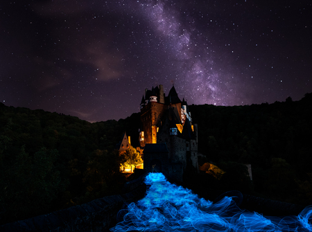 Milky way with light painting ghostly Castle Eltzのeditorial素材