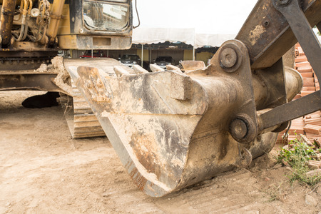 at a construction site there is a digging crane for the heavy work