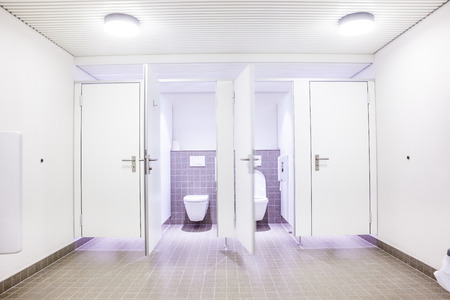 In an public building are womans toilets whit white doorsの写真素材