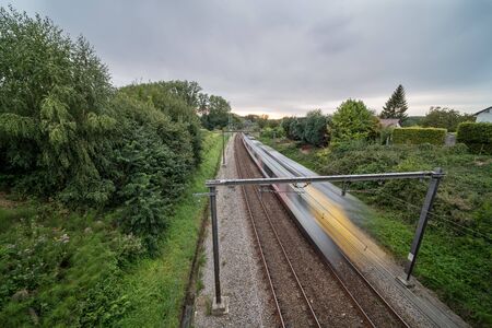 This passing train drives through a beautiful piece of nature