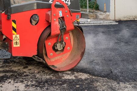 on asphalt asphalt rider there an asphalt roller to keep everything well pressedの写真素材