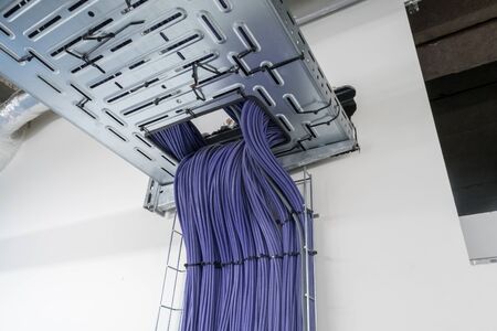 Electrical cables are located in a cableway on the roof of a buildingの写真素材