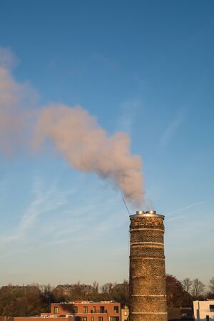 an brick fireplace with a thick plume of smokeの写真素材