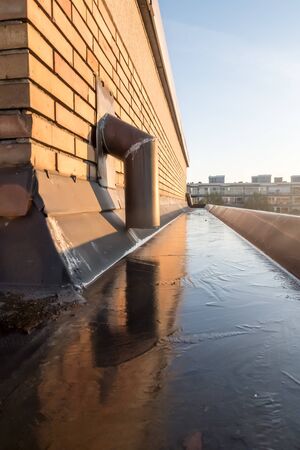 copper rain drainage and a copper gutter whose water is frozenの写真素材