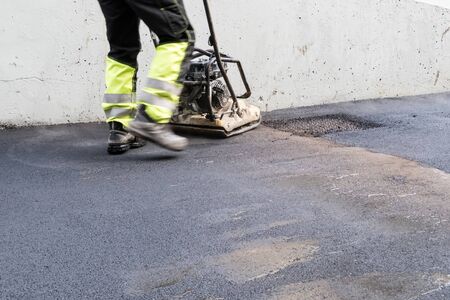 an top layer of asphalt is now laid on a surface