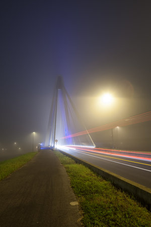 bridge whit blue light over the river whit fog in the morningの写真素材