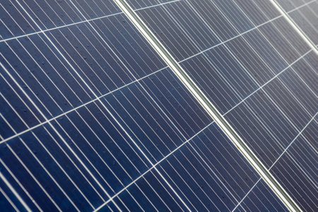 on an building in an residential area, there are solar panels on the roof on a cloudy day