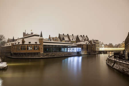 this old fish market stay in the heart of the city of Gent whit snow in the early morningの写真素材