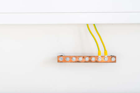 along the wall under an electric gutter there is a copper bar for electrical groundingの写真素材