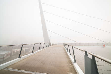 On a foggy morning along this beautiful bicycle pedestrian bridgeの写真素材