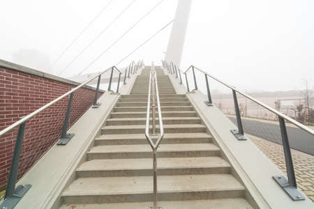 A concrete staircase for the bicycle pedestrian bridge on a missed morningの写真素材