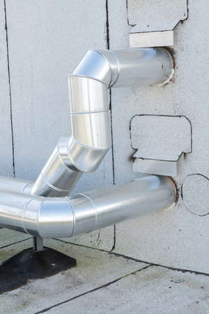 in the technical area on the roof, there are boosters for the water pipes of the buildingの写真素材