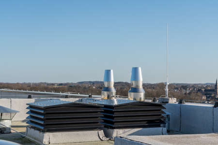 Chimney on the flat roof off a big building in the cityの写真素材