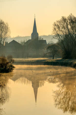 In the morning on a misty river with a beautiful church in the backgroundのeditorial素材