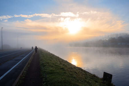 There is a lot of fog at the water sports track in Ghent so that the buildings are almost completely in the fogの写真素材