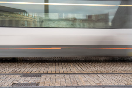 In Ghent, in the heart of this beautiful historic city, there is a passing tram.の写真素材