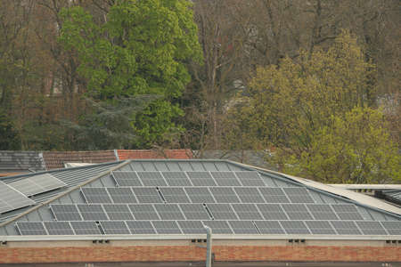 on an building in an residential area, there are solar panels on the roof