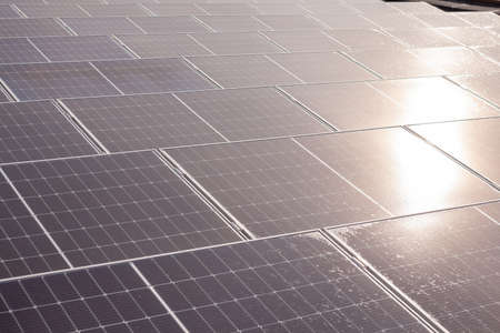 on an building in an residential area, there are solar panels on the roof on sunny day