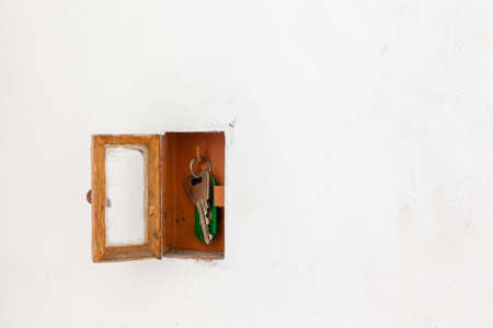 This single key cabinet is built into the wall next to a doorの写真素材