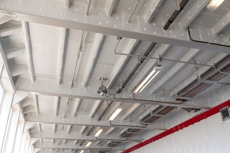 A security camera hangs from the iron ceiling to keep an eye on thingsの写真素材