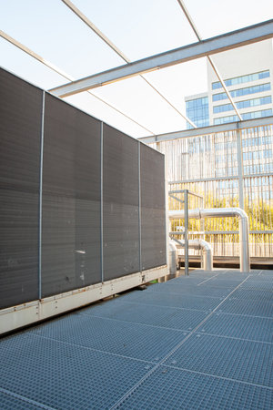 on an flat roof there is cooling air conditioning on an big building