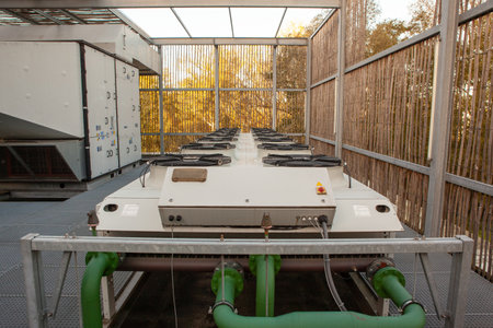 on an flat roof there is cooling air conditioning on an big buildingの写真素材