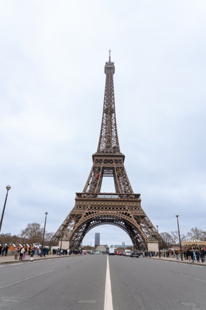 On a cloudy day the Eiffel Tower stands tall against a grey skyの写真素材