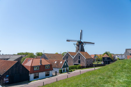 Early in the morning there is a beautiful windmill whit Blue sky