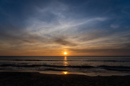 The end of a beautiful day with a beautiful sunset at the beachの写真素材