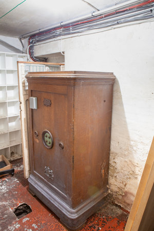 in the basement there is an old antique wooden safe with four wheelsの写真素材