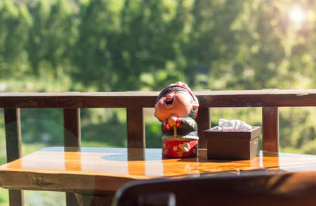 Dolly put on a natural wood background.の写真素材