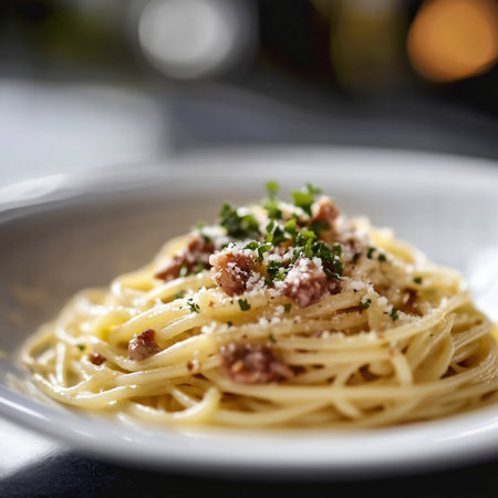 Spaghetti Carbonara with bacon and parmesan on white plateの素材