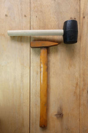 Steel hammer and Rubber Hammer on wooden backgroundの写真素材