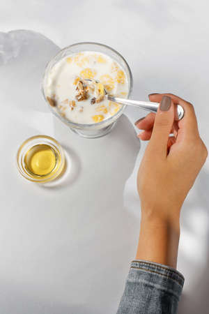 serving morning porridge with honey for the institution, shot from the topの写真素材